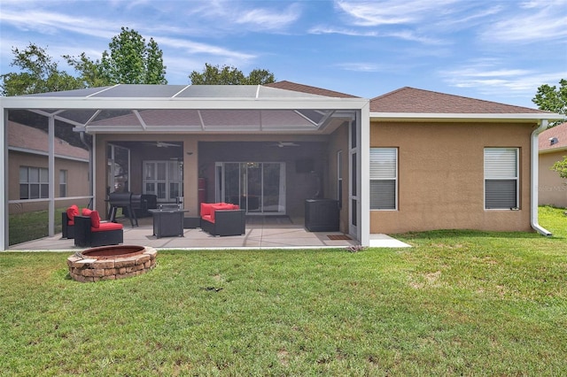9309 Edistro Pl, New Port Richey, FL 34654 - rear view of house featuring an outdoor fire pit, a patio, a lawn, a ceiling fan, and stucco siding