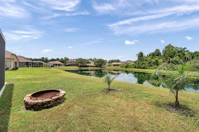 9309 Edistro Pl, New Port Richey, FL 34654 - view of green lawn featuring an outdoor fire pit, a water view, and a residential view