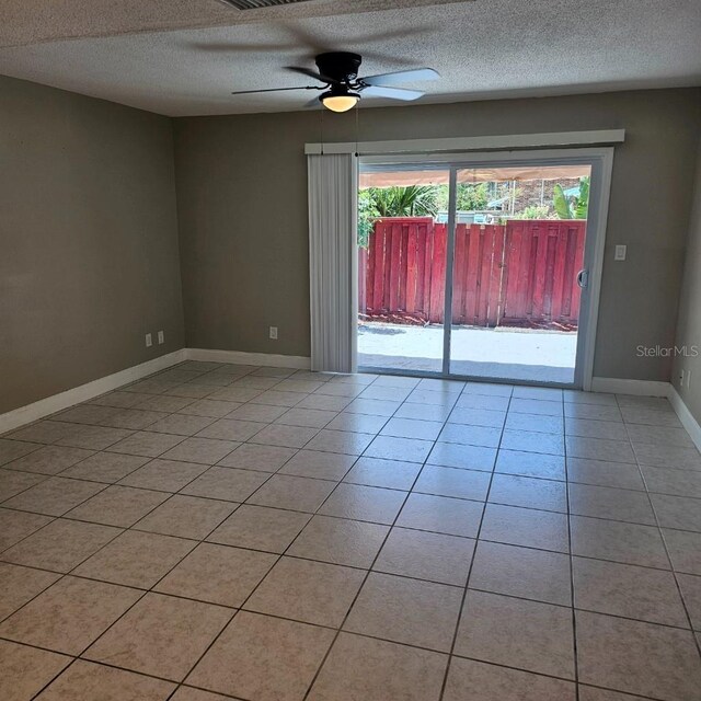 2200 S Palmetto Ave Unit E050, South Daytona, FL 32119 - unfurnished room featuring healthy amount of natural light, a textured ceiling, a ceiling fan, and light tile patterned floors