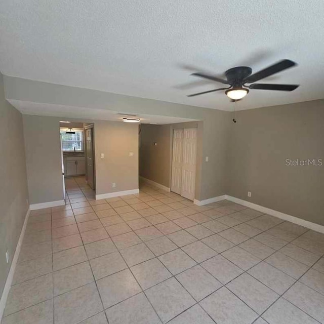 2200 S Palmetto Ave Unit E050, South Daytona, FL 32119 - spare room with a textured ceiling, light tile patterned floors, and a ceiling fan