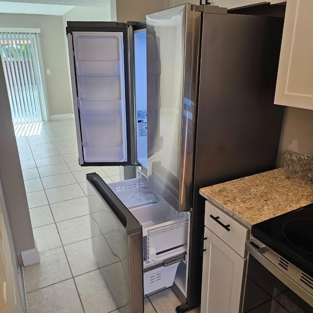2200 S Palmetto Ave Unit E050, South Daytona, FL 32119 - kitchen with light tile patterned flooring, white cabinets, stainless steel range oven, and light stone countertops