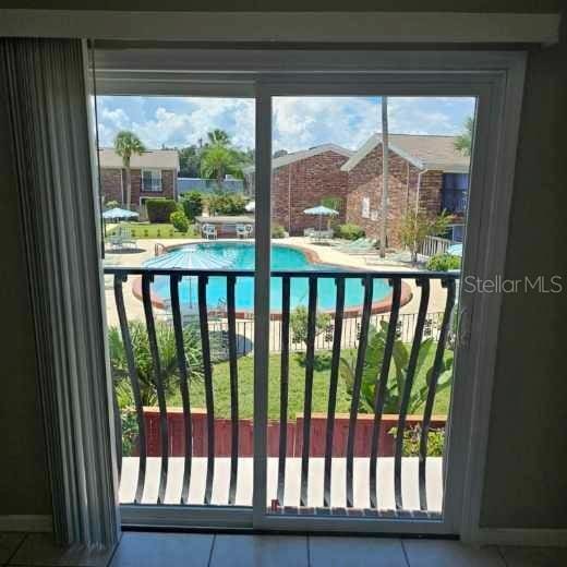 2200 S Palmetto Ave Unit E050, South Daytona, FL 32119 - doorway to outside featuring tile patterned flooring