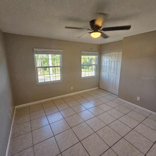 2200 S Palmetto Ave Unit E050, South Daytona, FL 32119 - unfurnished room featuring light tile patterned flooring, a textured ceiling, and ceiling fan