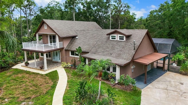 2202 Amity Ct, New Port Richey, FL 34655 - view of front of home featuring concrete driveway, roof with shingles, stucco siding, and a balcony