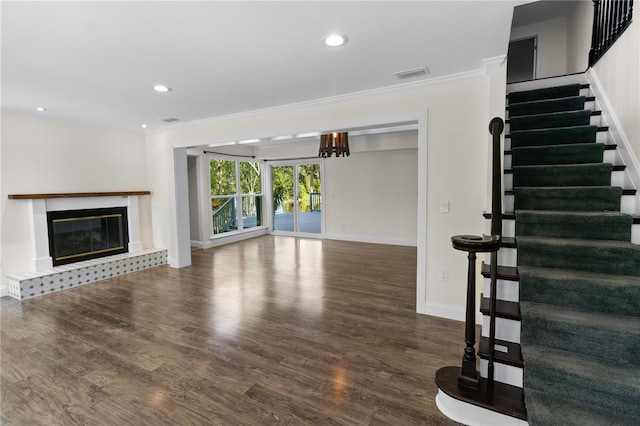 2202 Amity Ct, New Port Richey, FL 34655 - unfurnished living room featuring ornamental molding, wood finished floors, stairs, a tile fireplace, and recessed lighting