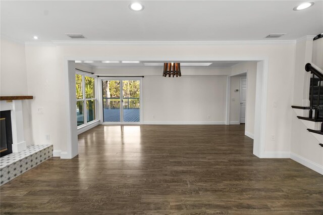 2202 Amity Ct, New Port Richey, FL 34655 - unfurnished living room featuring a glass covered fireplace, crown molding, wood finished floors, recessed lighting, and stairway