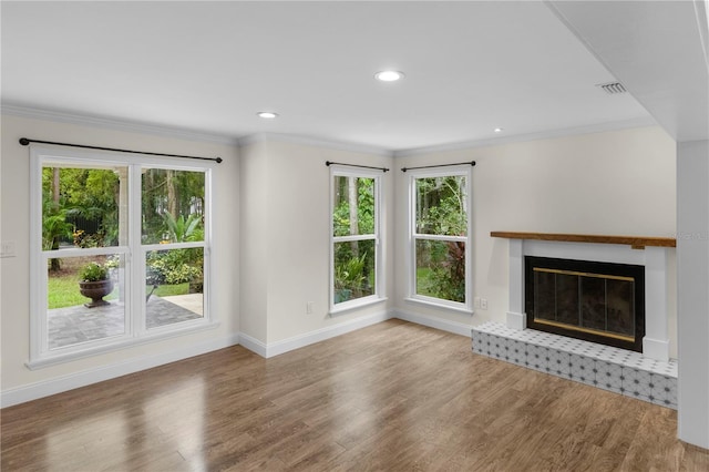 2202 Amity Ct, New Port Richey, FL 34655 - unfurnished living room with plenty of natural light, wood finished floors, crown molding, and recessed lighting