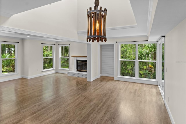 2202 Amity Ct, New Port Richey, FL 34655 - unfurnished living room featuring wood finished floors and a fireplace