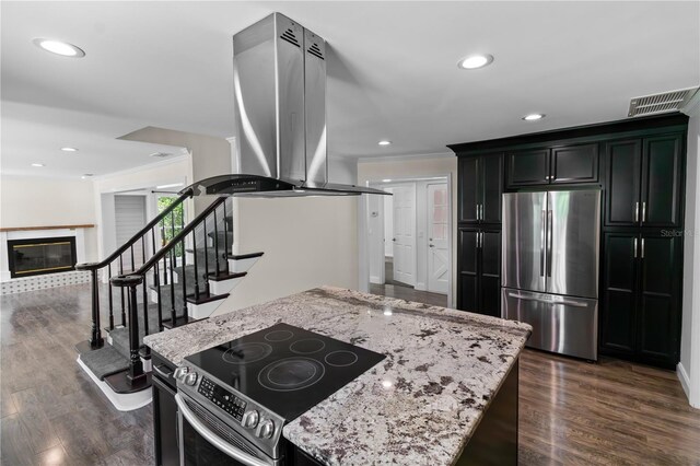 2202 Amity Ct, New Port Richey, FL 34655 - kitchen featuring stainless steel appliances, island range hood, ornamental molding, light stone counters, and dark wood-type flooring