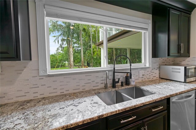 2202 Amity Ct, New Port Richey, FL 34655 - kitchen with decorative backsplash, stainless steel appliances, and light stone counters
