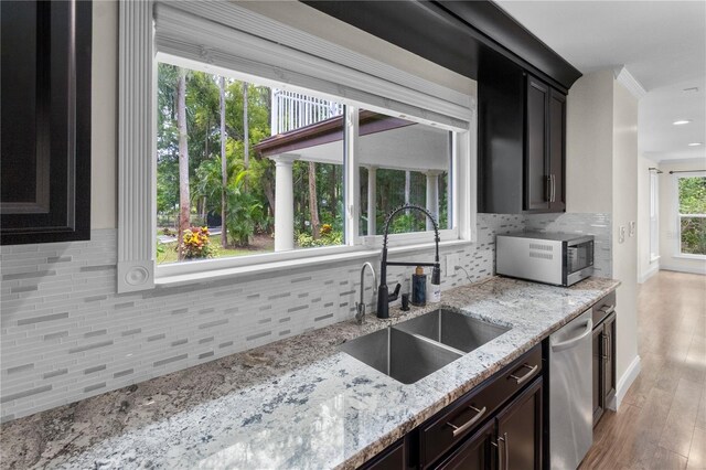 2202 Amity Ct, New Port Richey, FL 34655 - kitchen with dishwasher, backsplash, light wood-style flooring, and recessed lighting