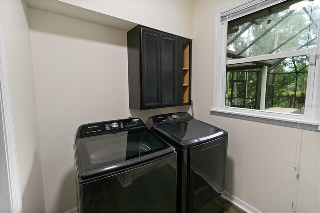 2202 Amity Ct, New Port Richey, FL 34655 - laundry area with independent washer and dryer, plenty of natural light, and cabinet space