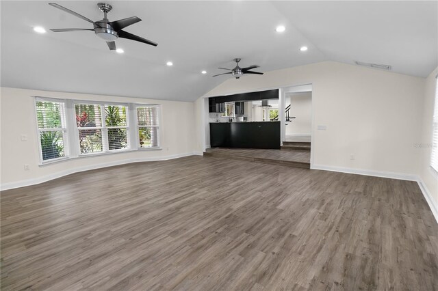 2202 Amity Ct, New Port Richey, FL 34655 - unfurnished living room featuring ceiling fan, vaulted ceiling, recessed lighting, and wood finished floors