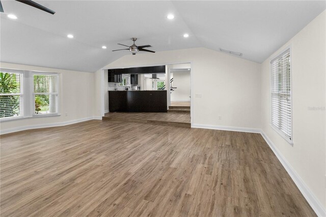 2202 Amity Ct, New Port Richey, FL 34655 - unfurnished living room with a ceiling fan, lofted ceiling, wood finished floors, and recessed lighting