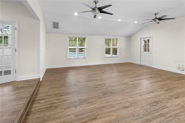 2202 Amity Ct, New Port Richey, FL 34655 - unfurnished living room featuring a ceiling fan, plenty of natural light, recessed lighting, vaulted ceiling, and wood finished floors