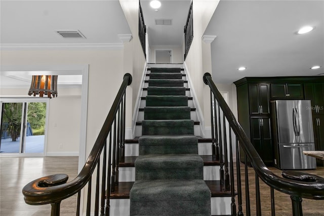 2202 Amity Ct, New Port Richey, FL 34655 - stairway with recessed lighting, ornamental molding, wood finished floors, and a chandelier