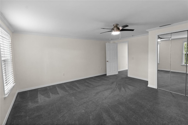 2202 Amity Ct, New Port Richey, FL 34655 - unfurnished bedroom with crown molding, dark carpet, a closet, and ceiling fan