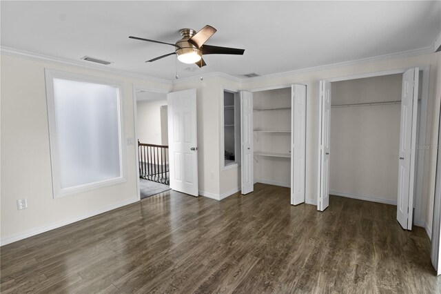 2202 Amity Ct, New Port Richey, FL 34655 - unfurnished bedroom featuring multiple closets, wood finished floors, ornamental molding, and ceiling fan
