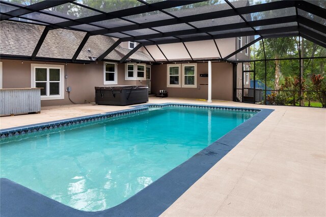 2202 Amity Ct, New Port Richey, FL 34655 - outdoor pool featuring a hot tub, a patio area, and glass enclosure