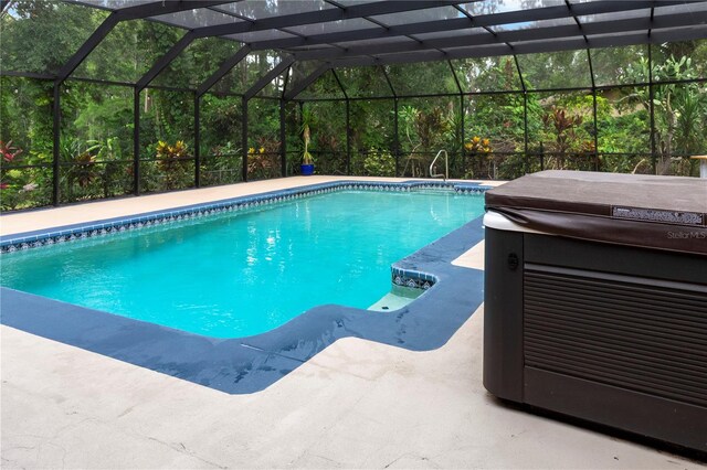 2202 Amity Ct, New Port Richey, FL 34655 - swimming pool with a hot tub, a patio, and glass enclosure