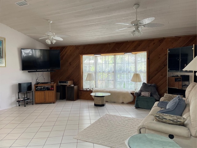 20971 Negril Ct, Lutz, FL 33558 - living room featuring ceiling fan, wood walls, light tile patterned floors, and lofted ceiling