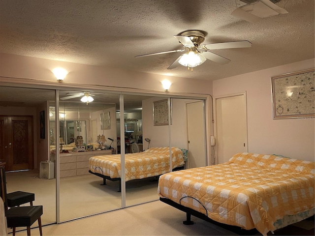 20971 Negril Ct, Lutz, FL 33558 - bedroom featuring light colored carpet, a textured ceiling, ceiling fan, and two closets