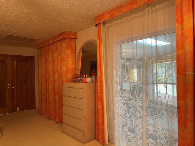 20971 Negril Ct, Lutz, FL 33558 - hallway featuring a textured ceiling, carpet flooring, and arched walkways