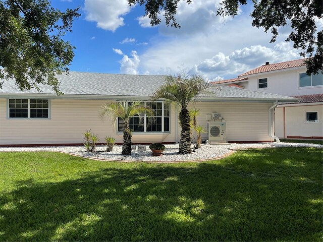 20971 Negril Ct, Lutz, FL 33558 - rear view of property featuring a lawn