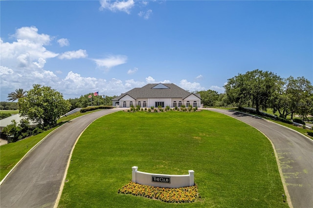 9406 Burnam Dr, Weeki Wachee, FL 34613 - french country style house featuring a front yard and driveway