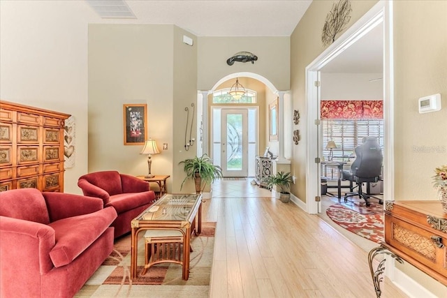9406 Burnam Dr, Weeki Wachee, FL 34613 - living area with light wood-style flooring and arched walkways