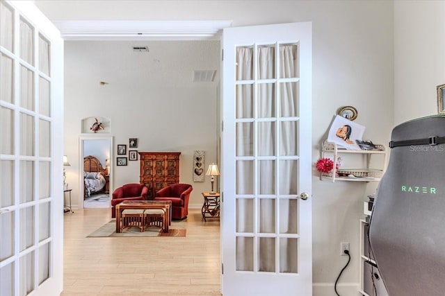 9406 Burnam Dr, Weeki Wachee, FL 34613 - doorway to outside featuring light wood-style flooring and french doors