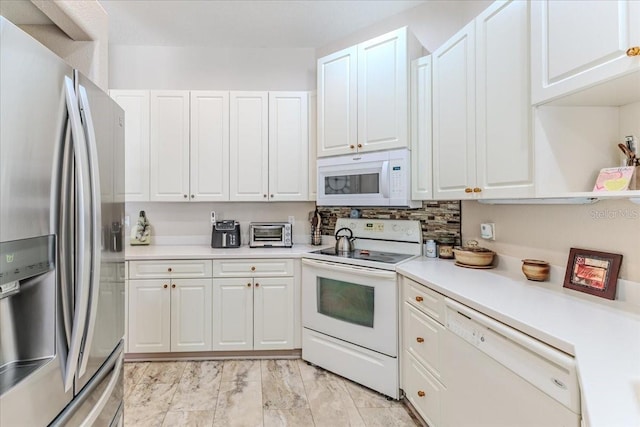 9406 Burnam Dr, Weeki Wachee, FL 34613 - kitchen with white appliances, white cabinetry, light countertops, and light marble finish flooring