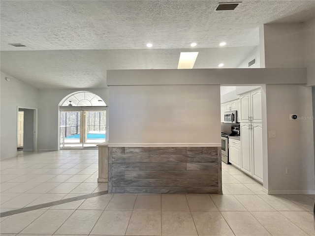 10060 Chip Ln, New Port Richey, FL 34654 - unfurnished room with a textured ceiling, light tile patterned floors, and recessed lighting