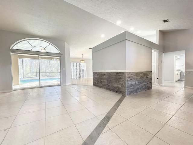 10060 Chip Ln, New Port Richey, FL 34654 - unfurnished room featuring a textured ceiling and light tile patterned floors
