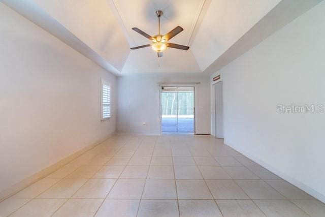 10060 Chip Ln, New Port Richey, FL 34654 - spare room featuring a tray ceiling, ceiling fan, and light tile patterned floors