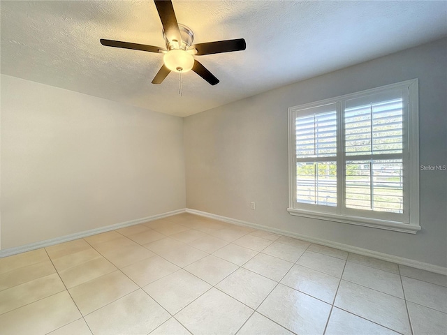 10060 Chip Ln, New Port Richey, FL 34654 - unfurnished room with light tile patterned flooring, ceiling fan, and a textured ceiling