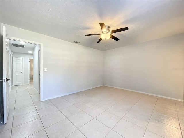 10060 Chip Ln, New Port Richey, FL 34654 - unfurnished room with light tile patterned floors, a ceiling fan, and a textured ceiling