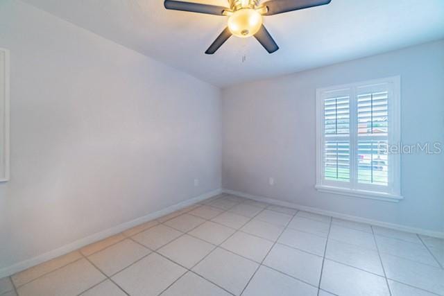 10060 Chip Ln, New Port Richey, FL 34654 - spare room featuring ceiling fan and light tile patterned floors