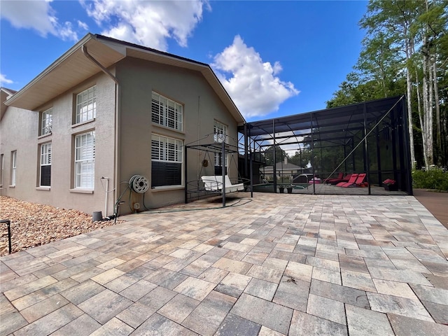 10060 Chip Ln, New Port Richey, FL 34654 - back of house with a patio area, stucco siding, and a lanai