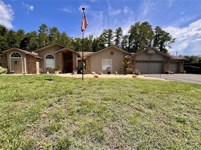 10060 Chip Ln, New Port Richey, FL 34654 - single story home featuring stucco siding, a front yard, a garage, driveway, and stone siding