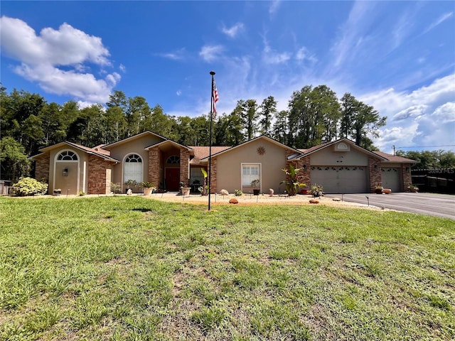 10060 Chip Ln, New Port Richey, FL 34654 - ranch-style home featuring a front yard, an attached garage, stucco siding, stone siding, and driveway