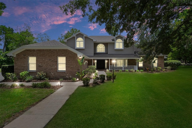 7268 Crystal Spring Run, Weeki Wachee, FL 34607 - view of front of house featuring a front lawn, covered porch, and brick siding