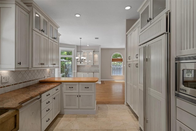 7268 Crystal Spring Run, Weeki Wachee, FL 34607 - kitchen featuring built in appliances, healthy amount of natural light, decorative backsplash, a peninsula, and recessed lighting