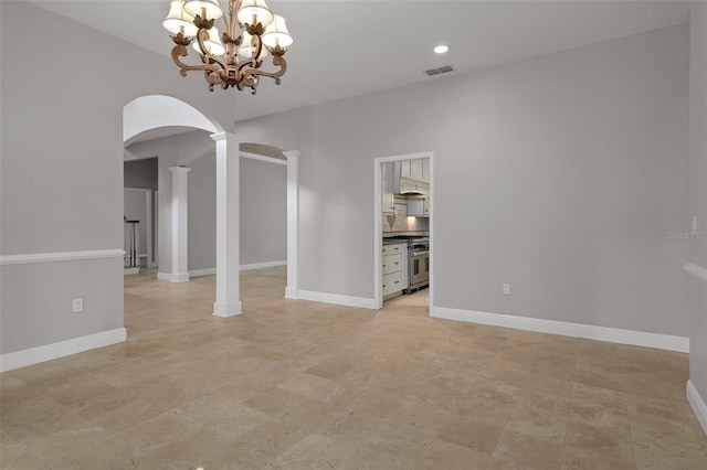 7268 Crystal Spring Run, Weeki Wachee, FL 34607 - spare room featuring arched walkways, a chandelier, recessed lighting, and decorative columns