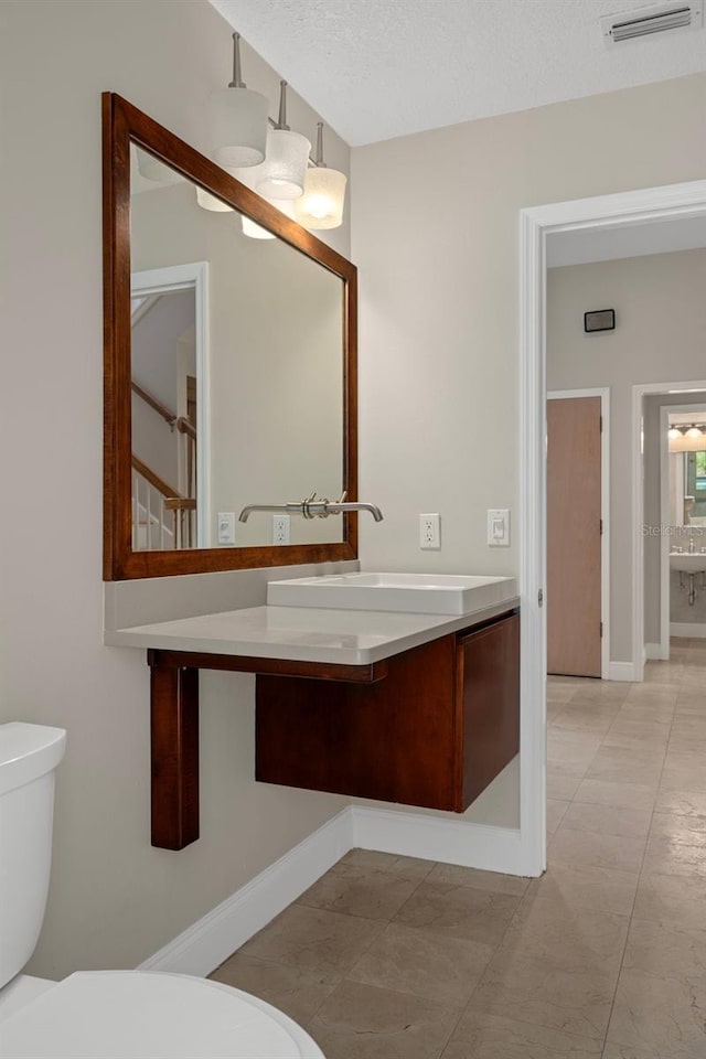 7268 Crystal Spring Run, Weeki Wachee, FL 34607 - bathroom with vanity, a textured ceiling, and tile patterned flooring