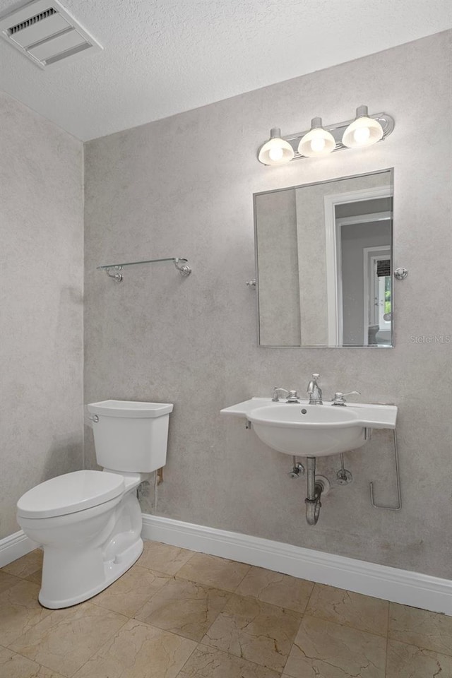 7268 Crystal Spring Run, Weeki Wachee, FL 34607 - bathroom with marble look tiles and a textured ceiling