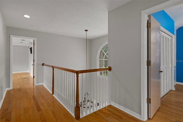 7268 Crystal Spring Run, Weeki Wachee, FL 34607 - hallway featuring light wood-type flooring, an upstairs landing, and recessed lighting