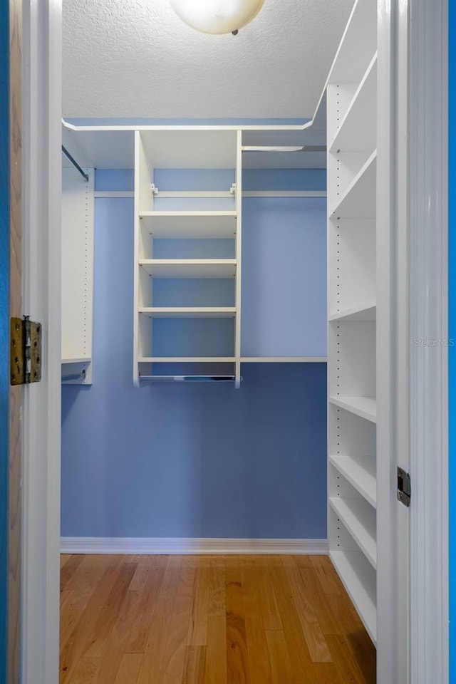 7268 Crystal Spring Run, Weeki Wachee, FL 34607 - spacious closet featuring wood finished floors