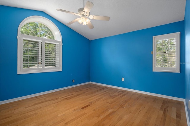 7268 Crystal Spring Run, Weeki Wachee, FL 34607 - spare room with vaulted ceiling, healthy amount of natural light, wood finished floors, and ceiling fan