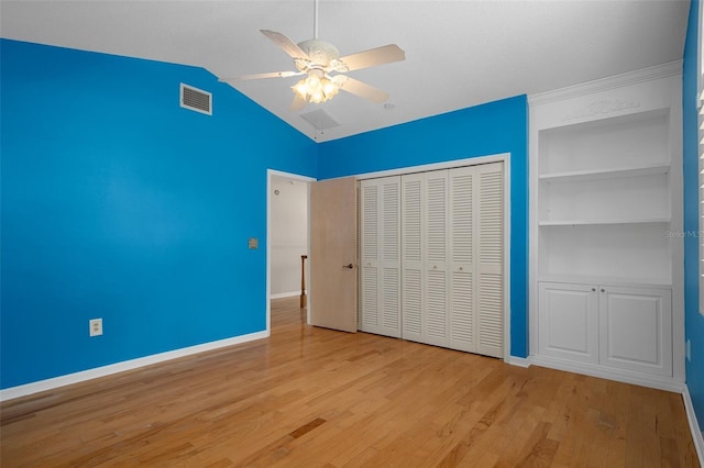 7268 Crystal Spring Run, Weeki Wachee, FL 34607 - unfurnished bedroom with wood finished floors, vaulted ceiling, a closet, and ceiling fan
